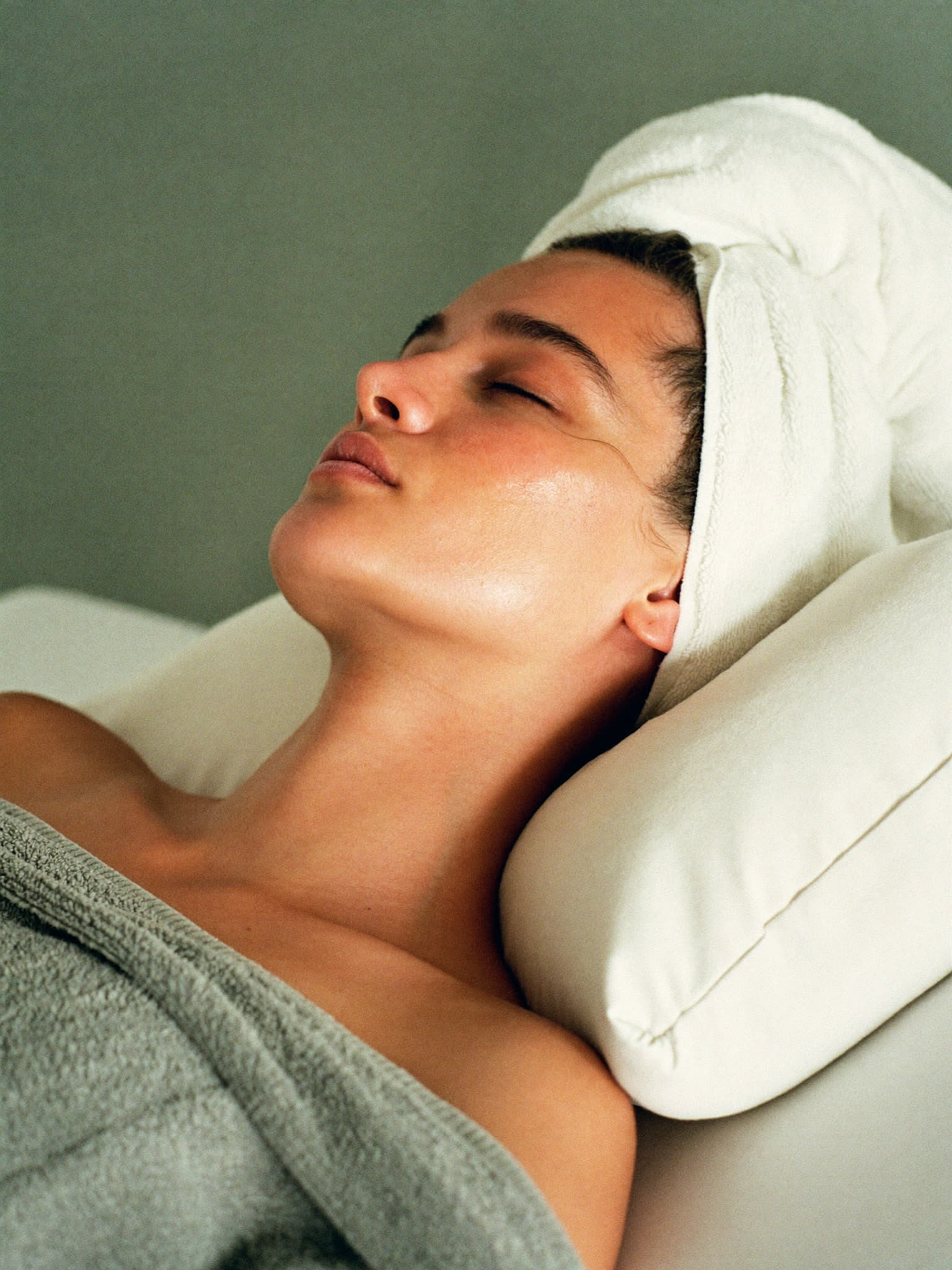 A client resting after a facial, skin glowing